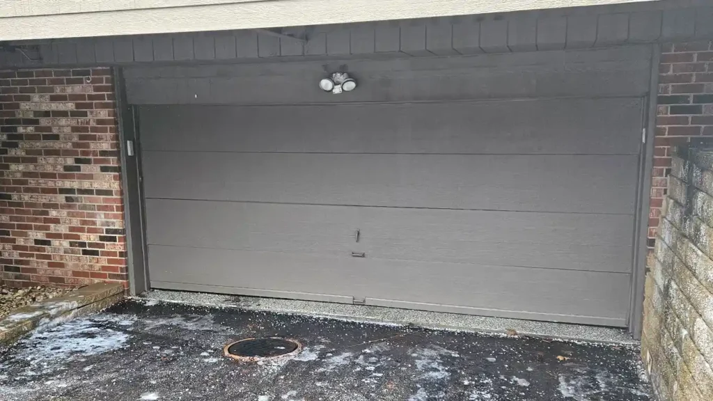 In winter, garage doors need proper lubrication. The photo shows a door on the brink of failure.
