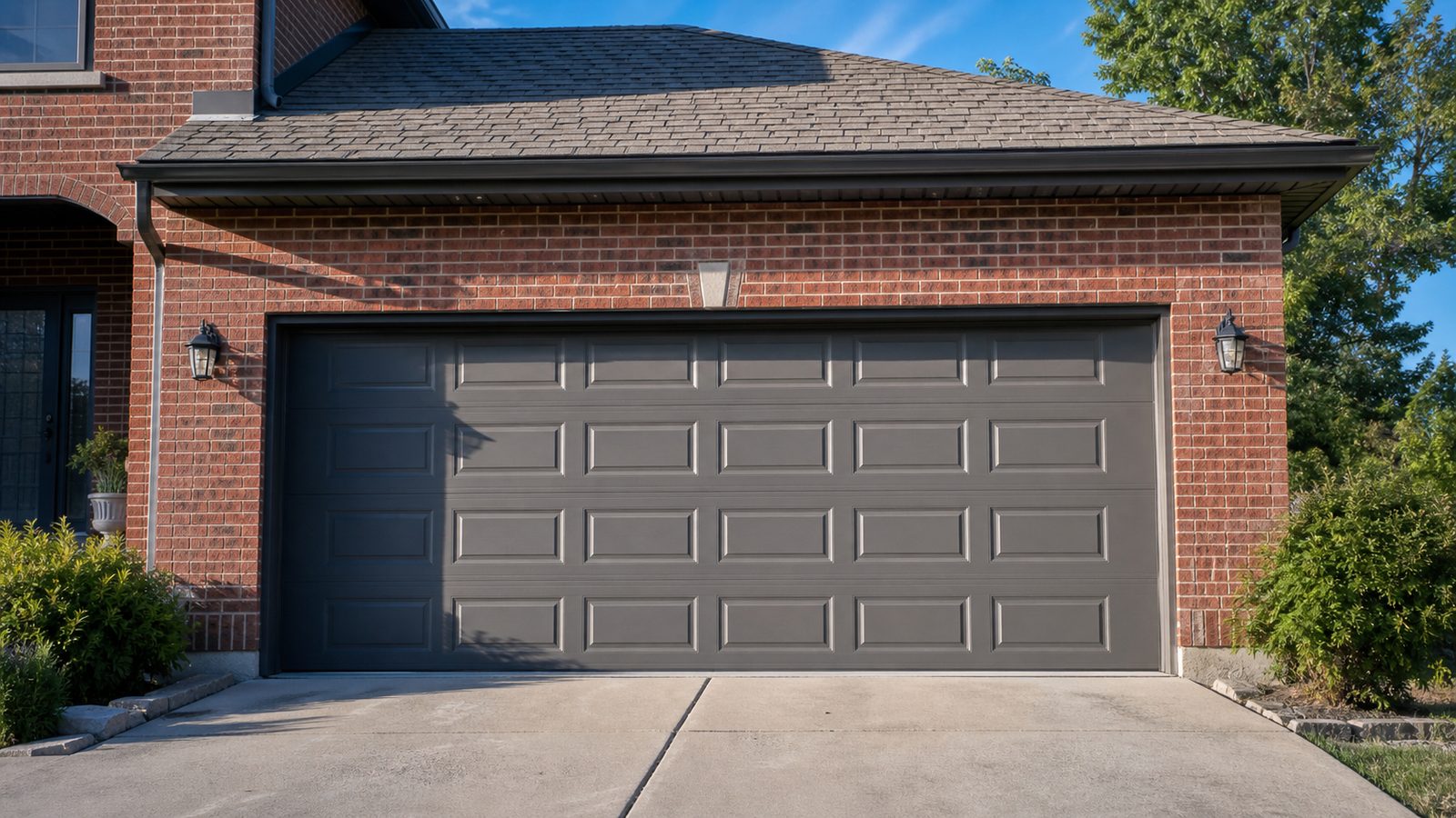 Two-car steel garage door on an attached brick suburban Chicago home in late-afternoon summer sun